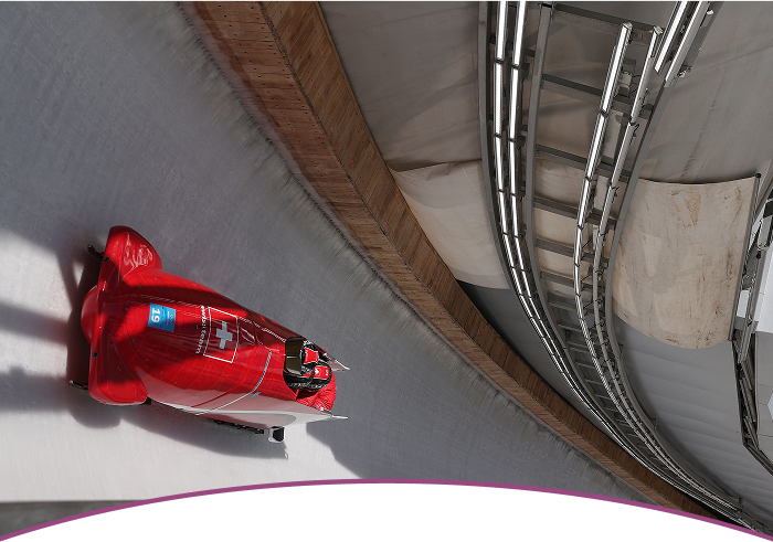 Switzerland bobsleigh team racing down an icy track at the Olympic Winter Games Beijing 2022.